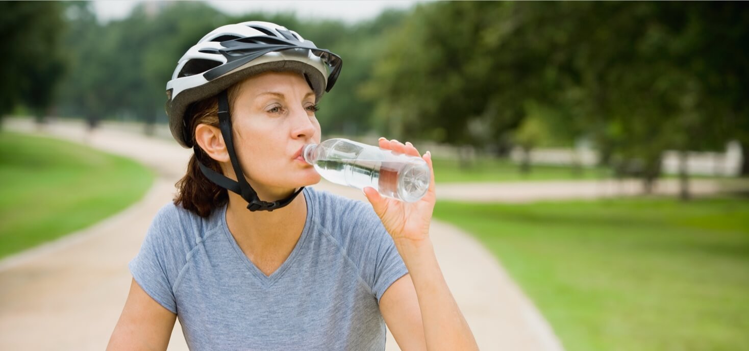 Person drinking water on a bike